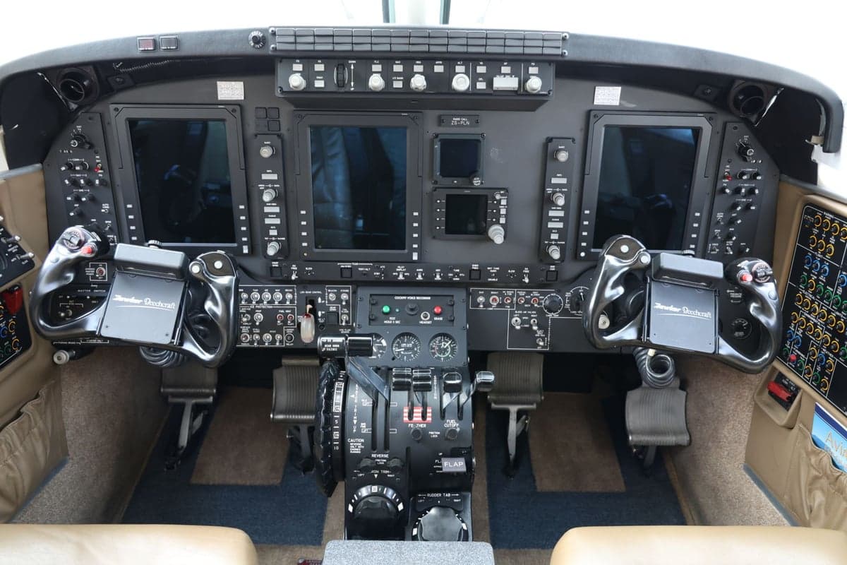 Full instrument panel and controls in the cockpit of an aircraft.