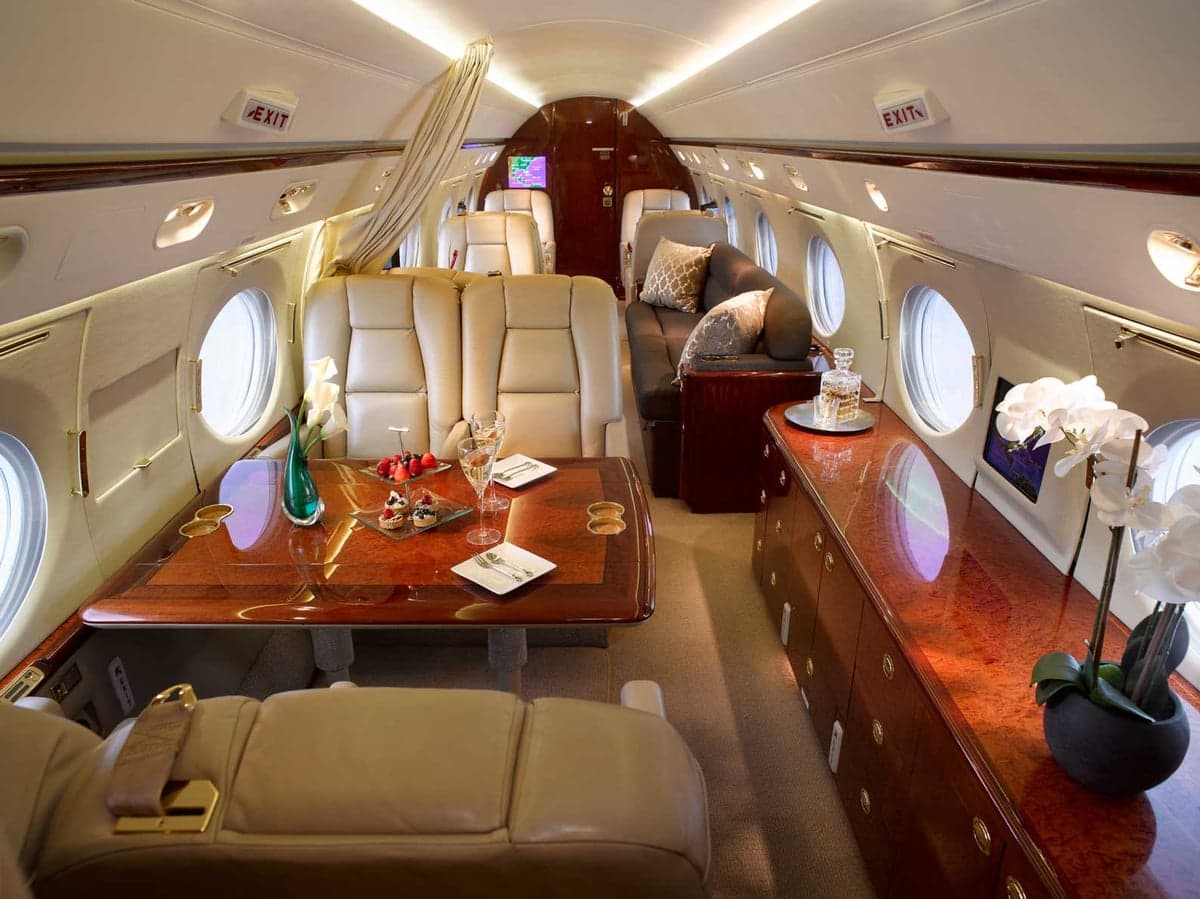 Interior view of the aircraft cabin with a table set for a meal.