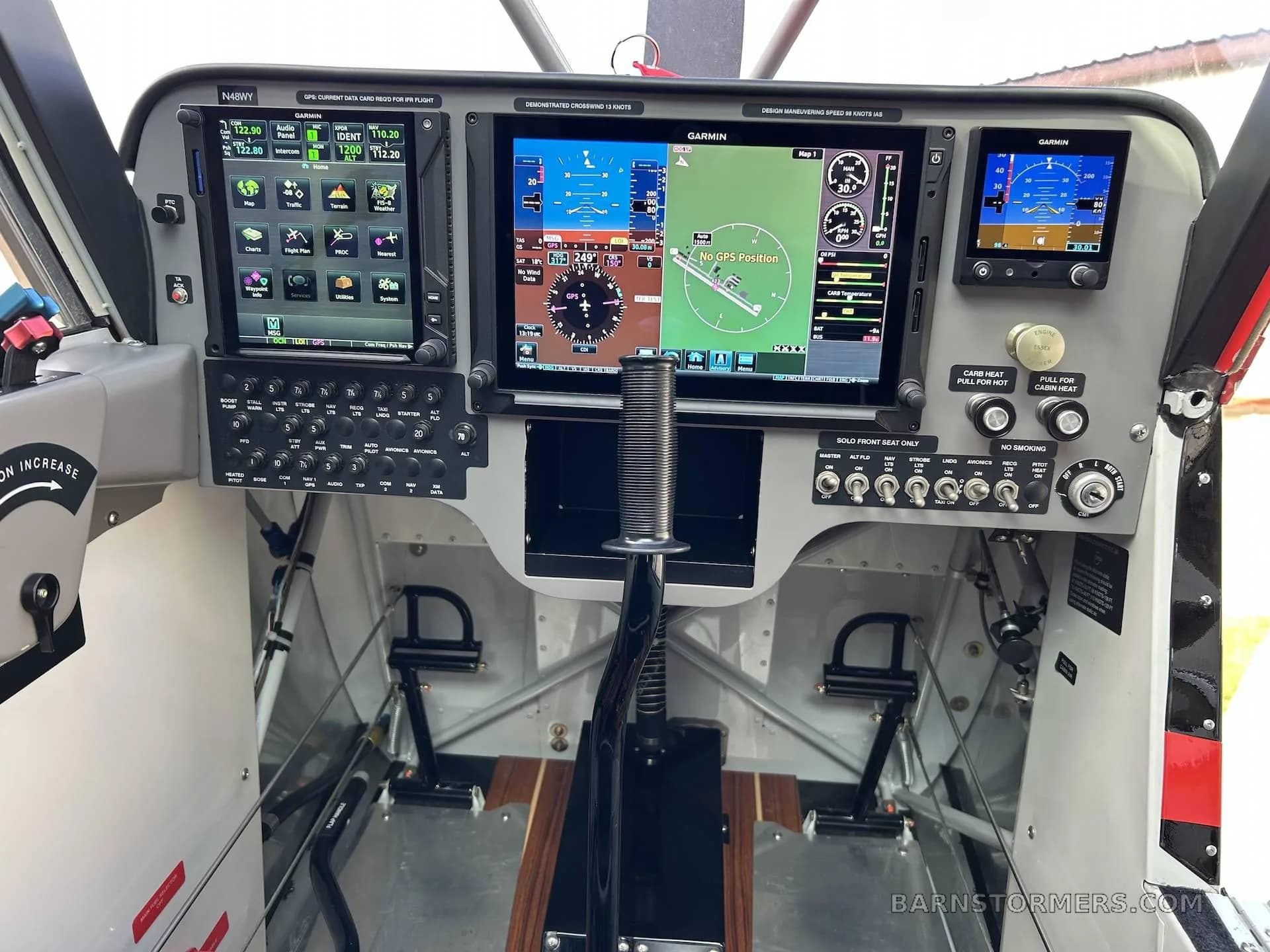 The modern glass cockpit of the Aviat Husky A-1C aircraft features multiple Garmin displays and flight controls.