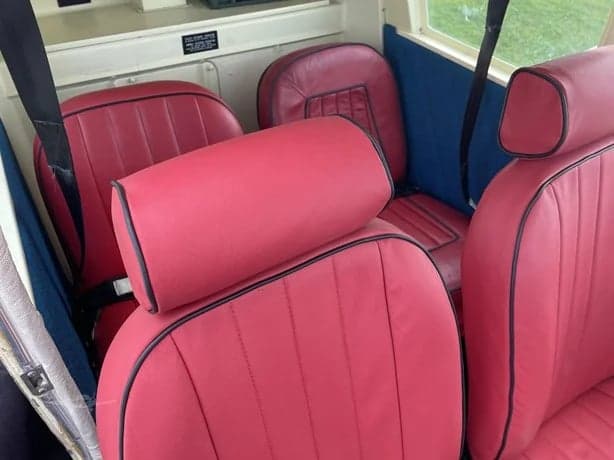 Close-up of the red leather seats inside the aircraft cabin.