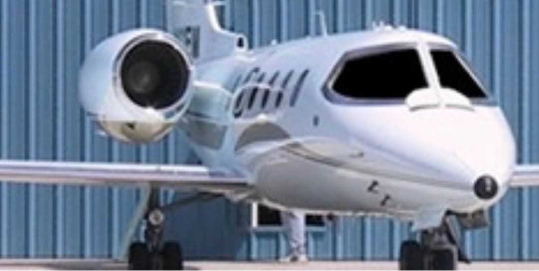 Front view of a white aircraft with blacked-out windows.