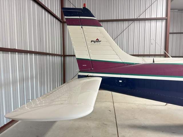 Close-up view of the tail section of the Piper Saratoga II TC aircraft, showing the vertical and horizontal stabilizers.