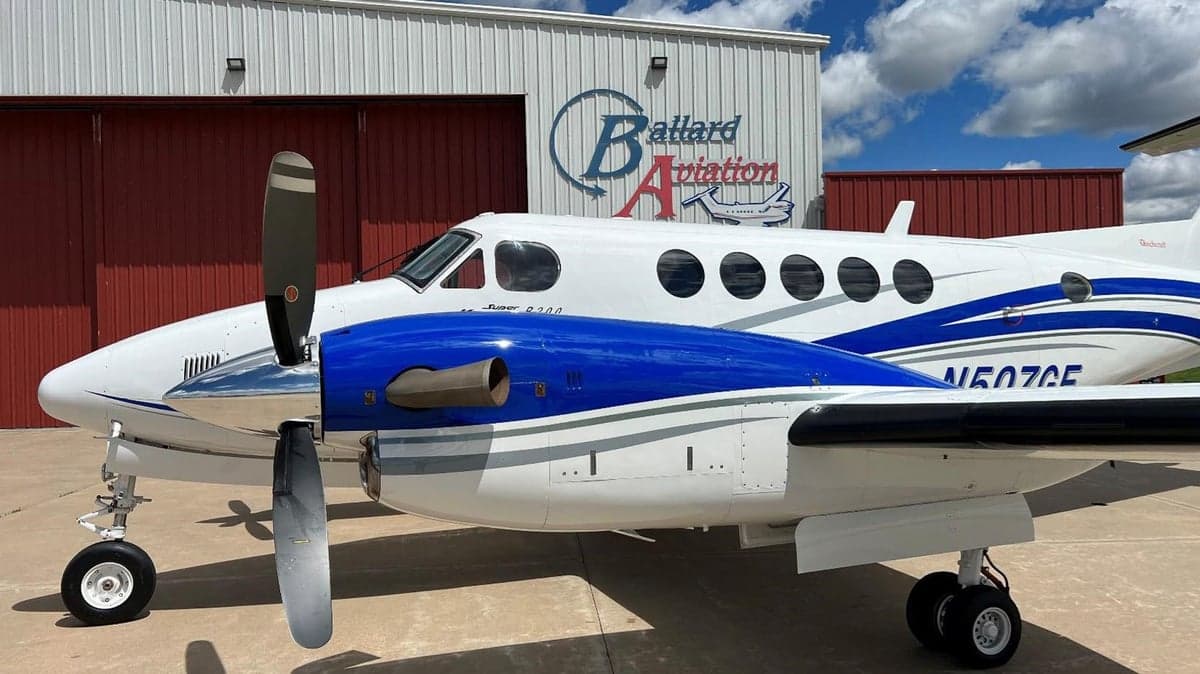 Side view of a Beechcraft King Air with blue and white paint scheme.