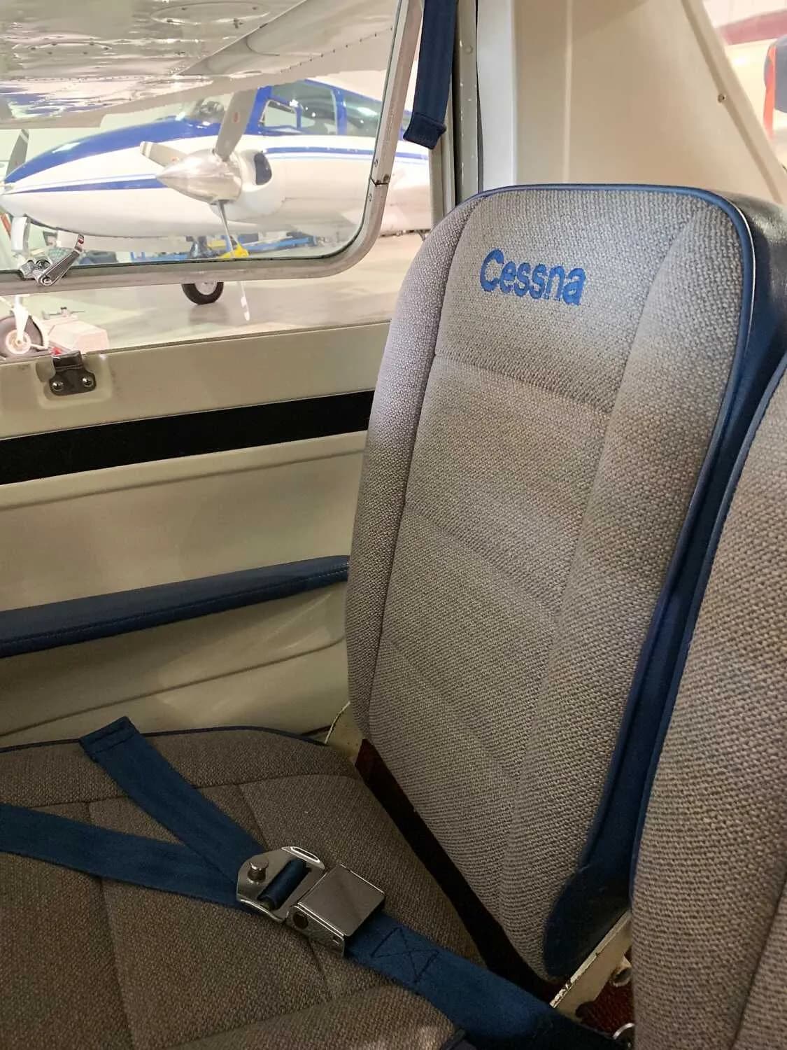 Front seats of a Cessna 172 Skyhawk with 'Cessna' embroidered on the seat.