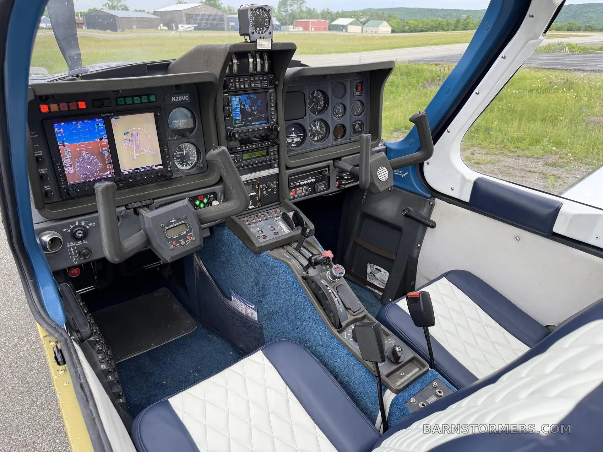 The cockpit of a Socata Trinidad TB20, featuring modern avionics displays and traditional gauges.