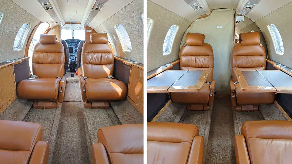 The interior of a Cessna Citation CJ1 aircraft, showing the leather seats and tables.