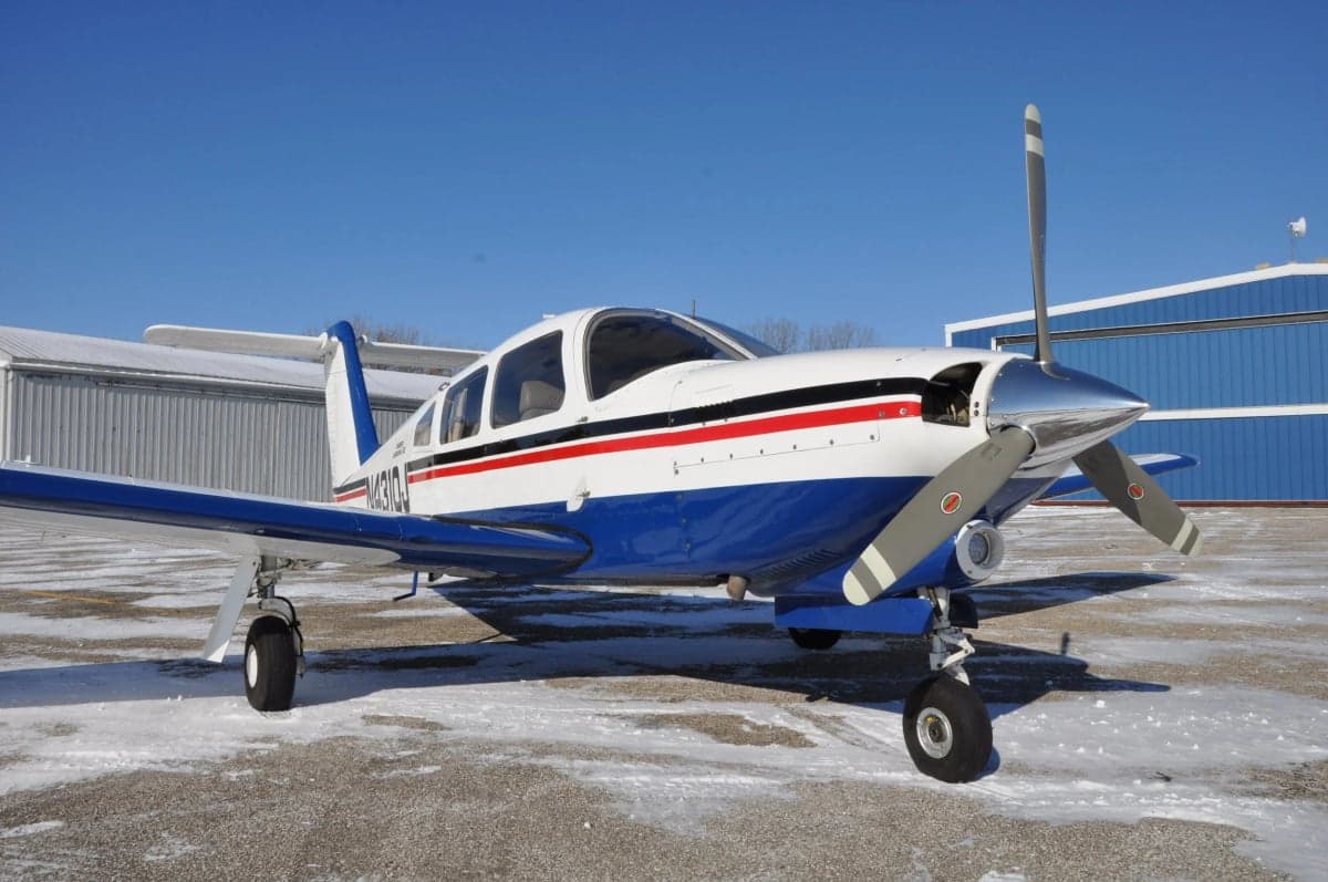 Piper Arrow on a snowy ramp, front quarter view.