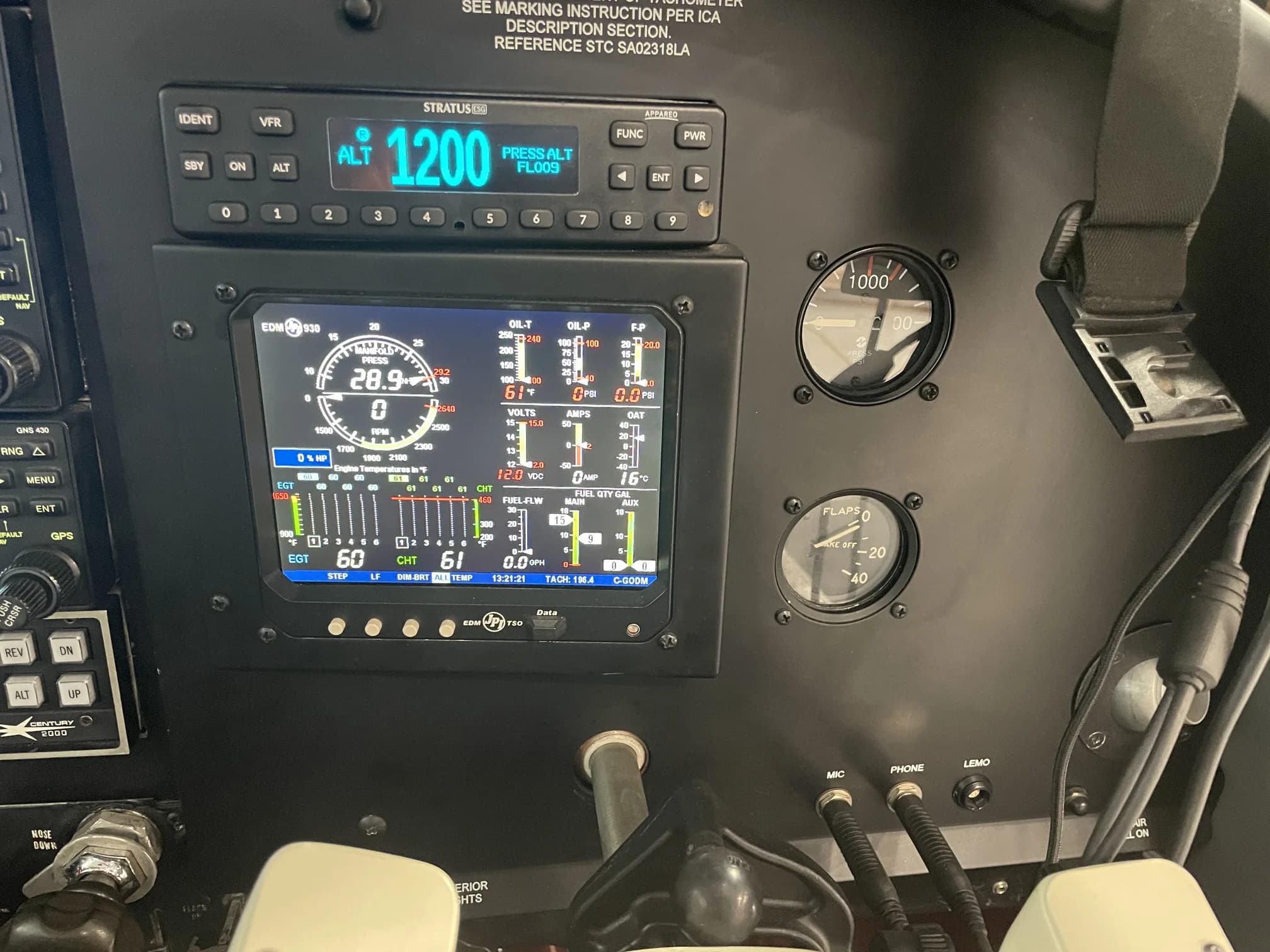 A close-up of an aircraft's instrument panel, showing a digital engine monitor and other flight instruments.