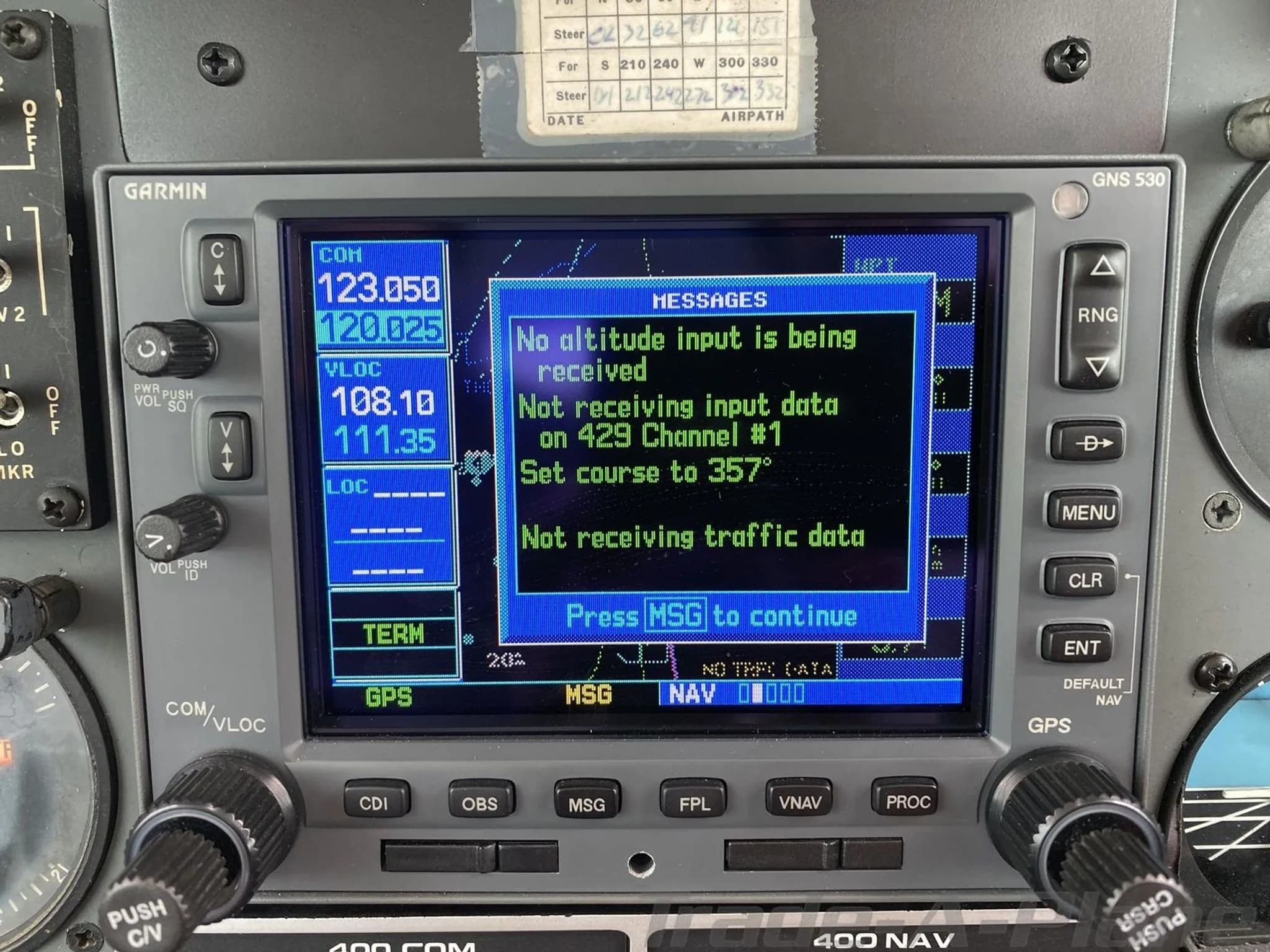 A close-up view of the Garmin GNS 530 navigation display in the cockpit, showing messages.