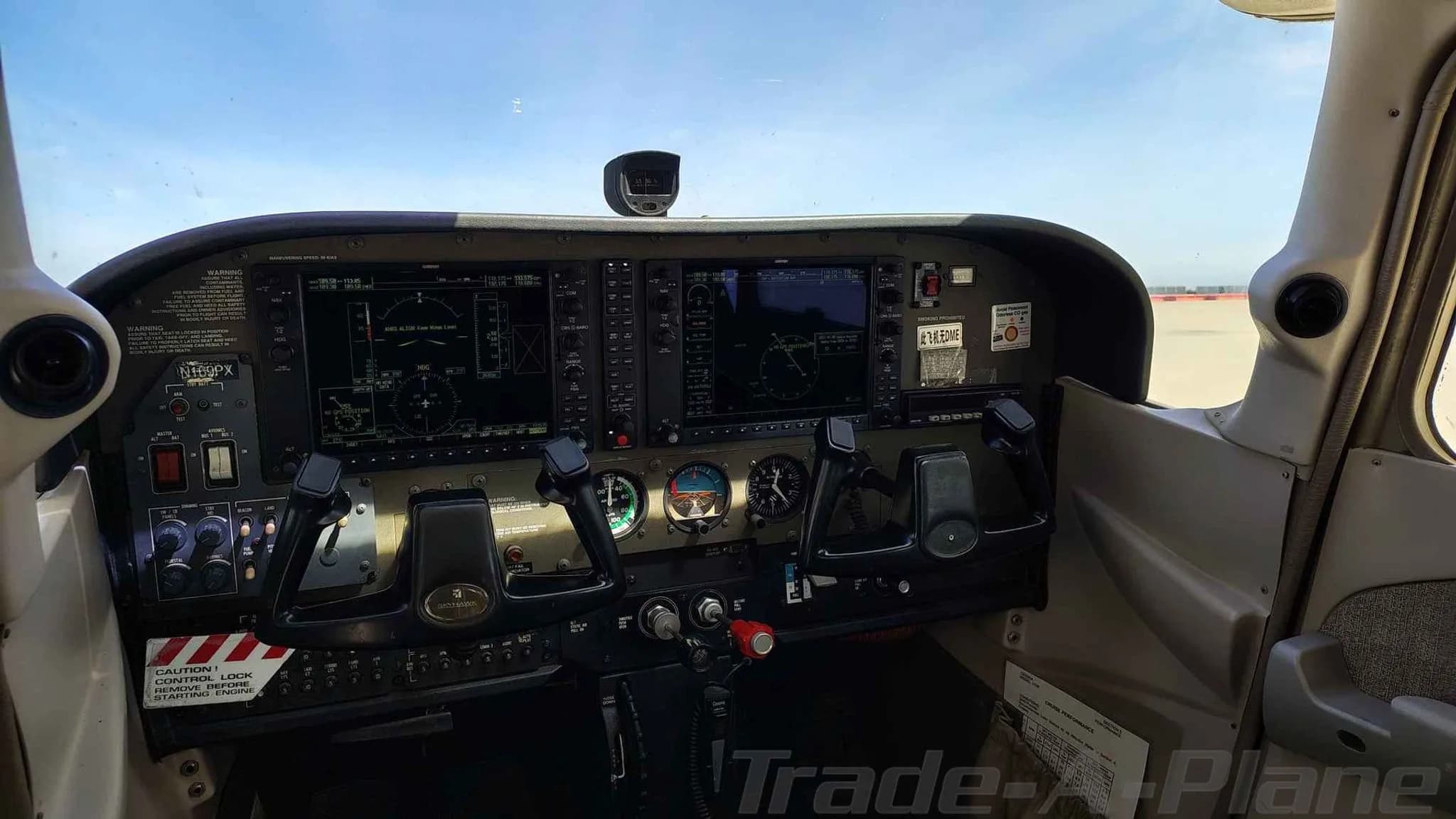 The cockpit of the aircraft, featuring a modern glass panel display and dual yokes.