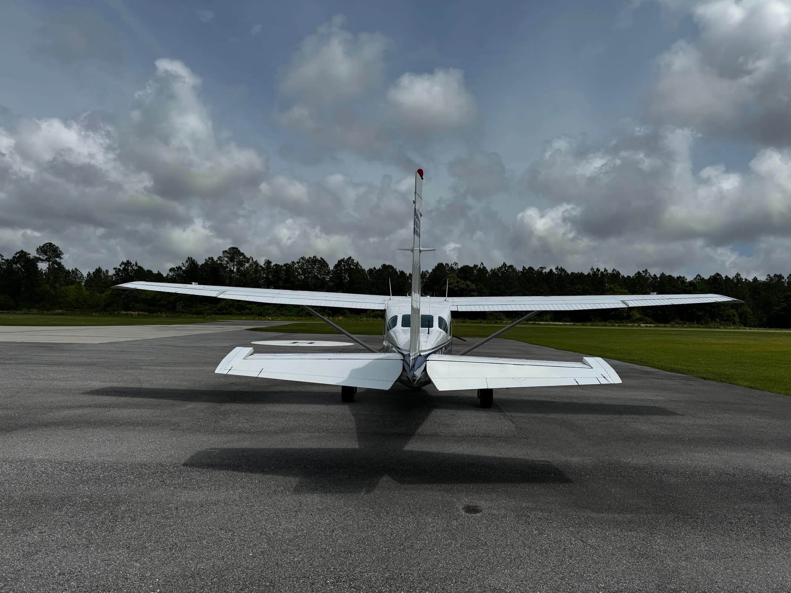 Rear view of a white and blue Cessna 206 Turbo Stationair on the tarmac.