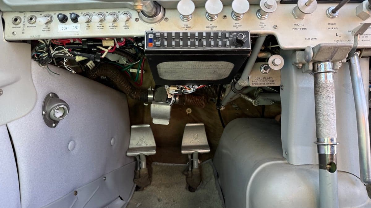 View of the rudder pedals and lower instrument panel of the aircraft.