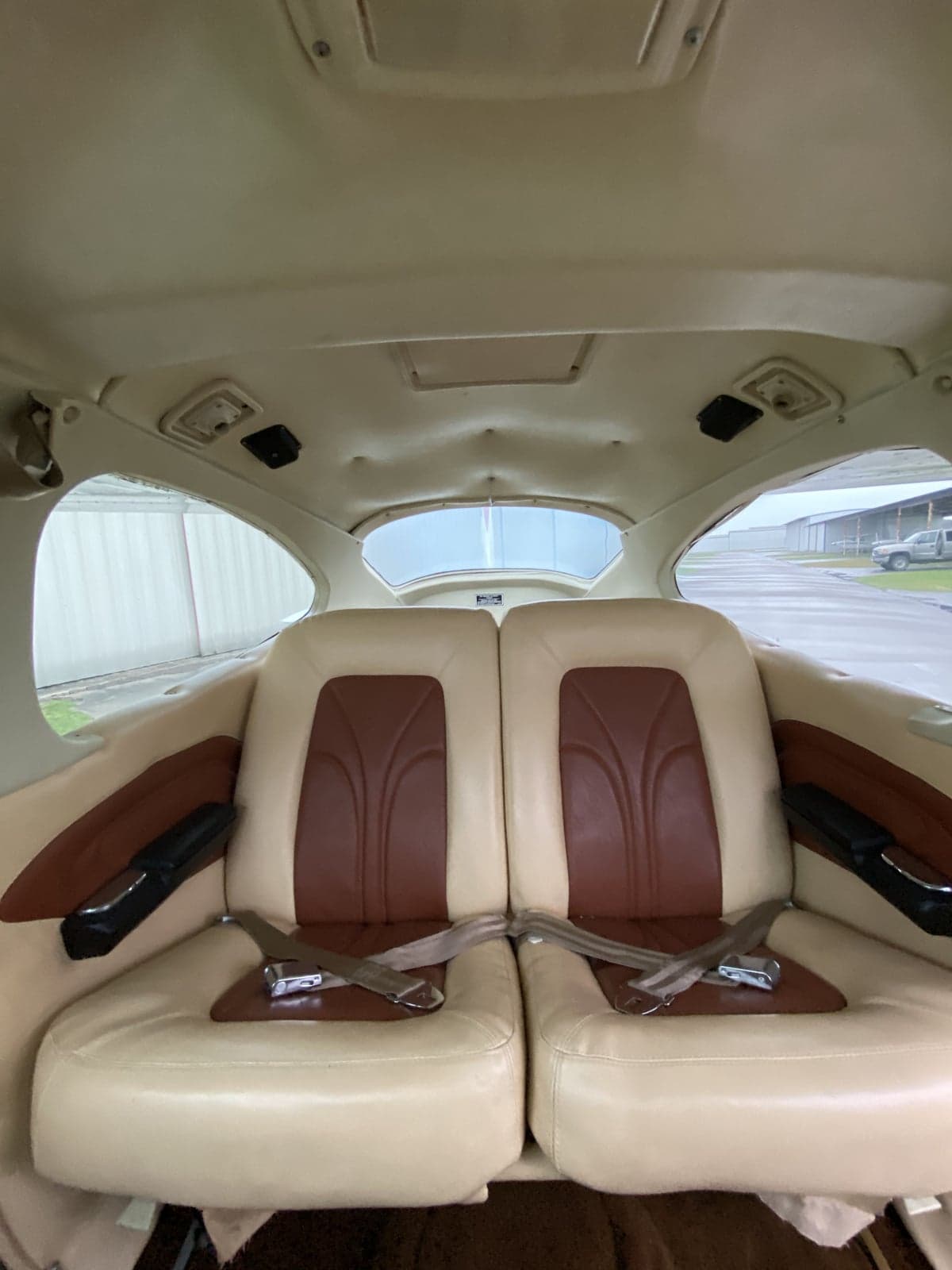 The rear seats of a Cessna 177RG Cardinal are upholstered in tan and brown leather.