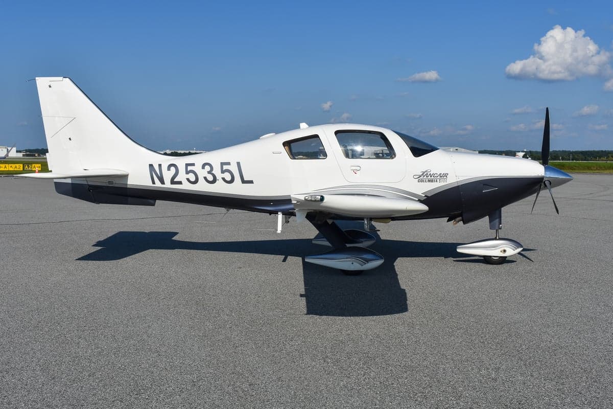 Close-up of the front of a Lancair Columbia 400 aircraft on the tarmac.