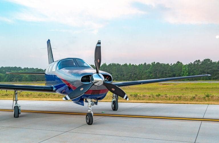 Front view of a Piper Mirage on the runway.