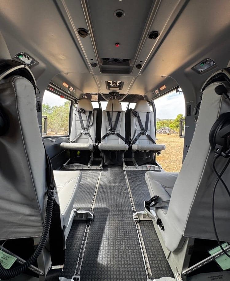 Helicopter cabin with forward and rear-facing seats.