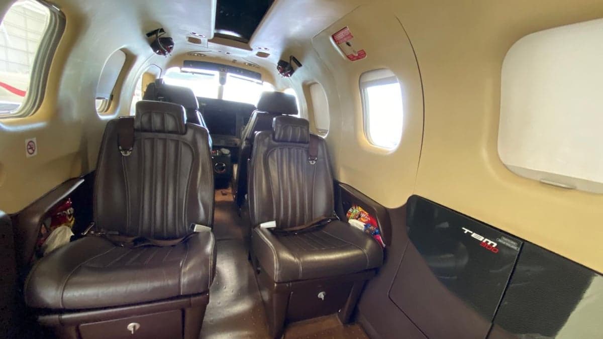View of the cabin interior with leather seats and cockpit.