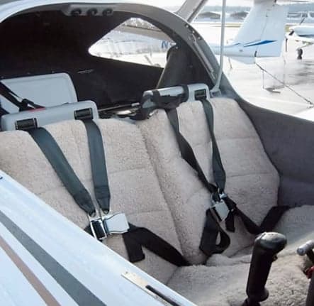 Interior view of the aircraft cabin with sheepskin seat covers.