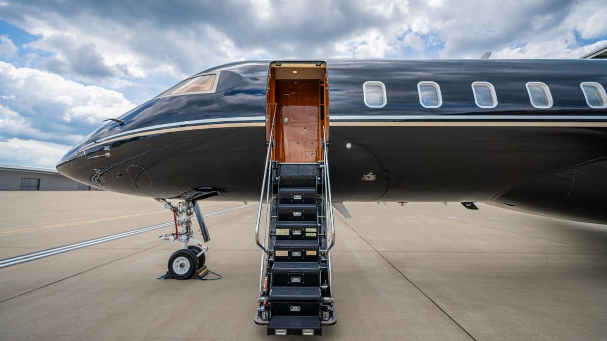 Close up of the stairs leading into a black and silver jet.