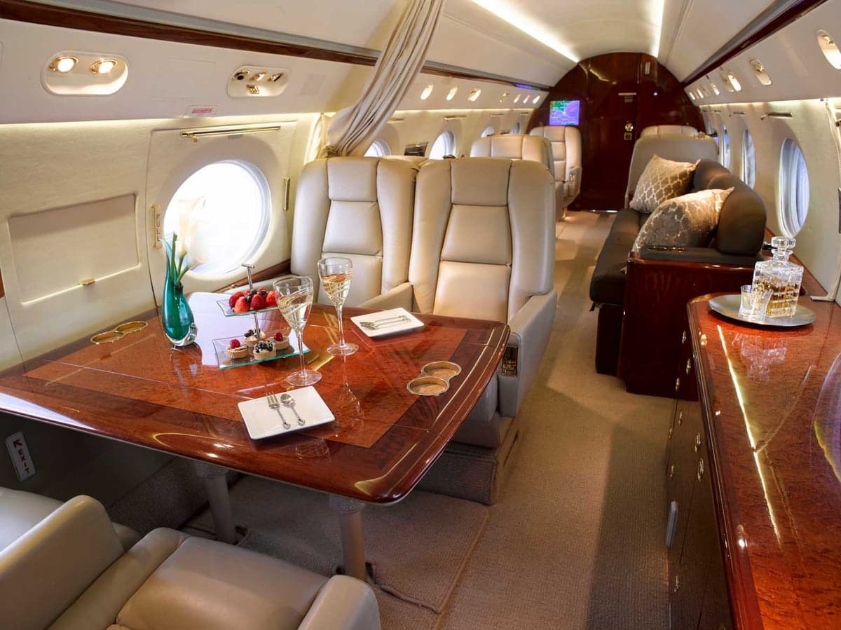 Interior view of the aircraft cabin with a table set for a meal.