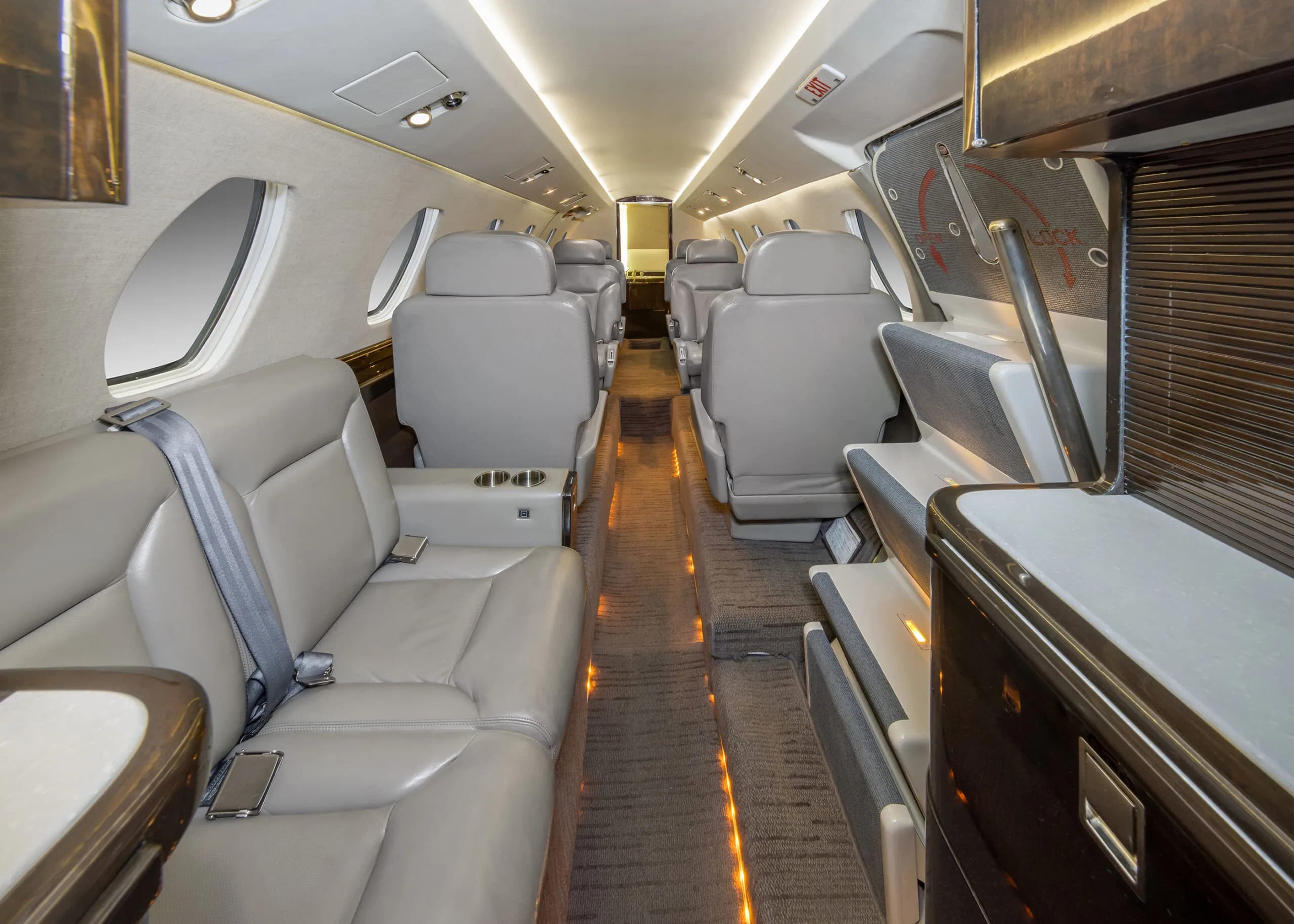 View of the cabin interior showing seats and side tables.