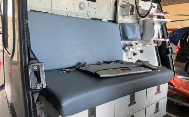 The helicopter's interior includes a stretcher and seating.
