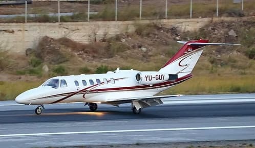 A Cessna Citation CJ1 with registration YU-GUY on the runway.