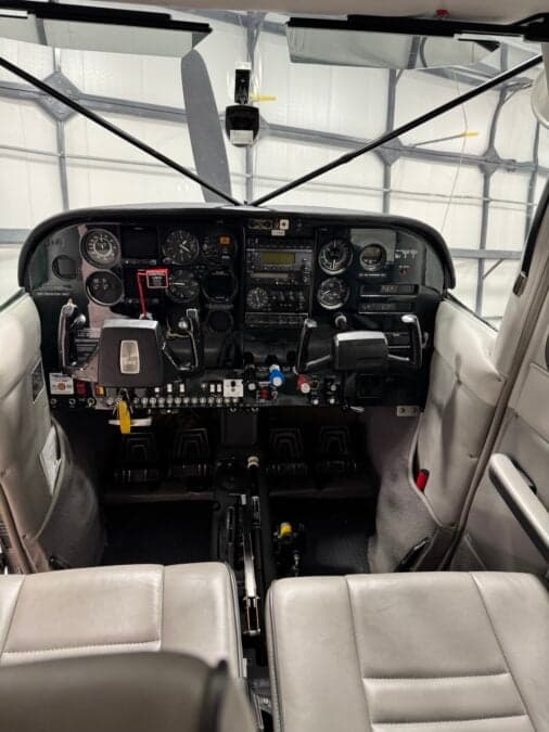View of the cockpit instrument panel and front seats.