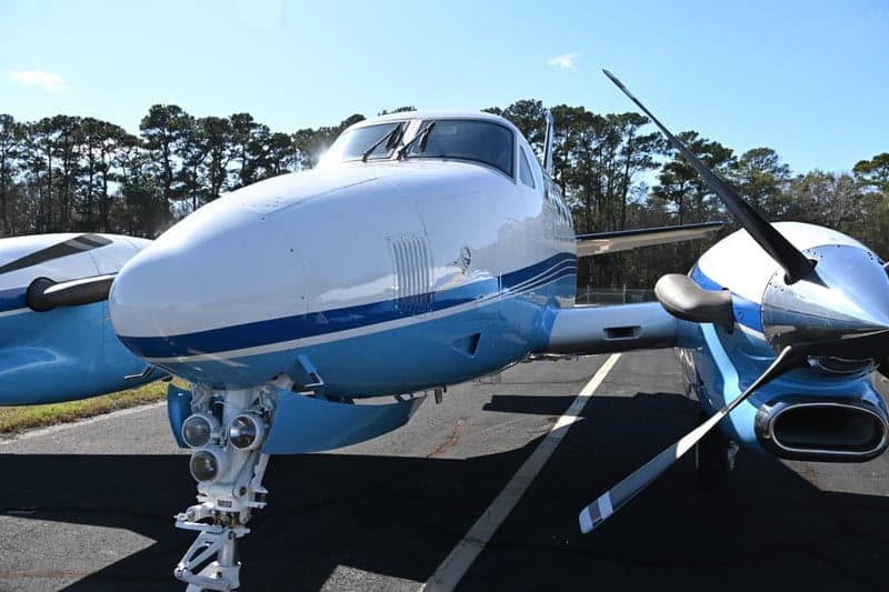 Close up of the nose and propeller of a Beechcraft King Air.