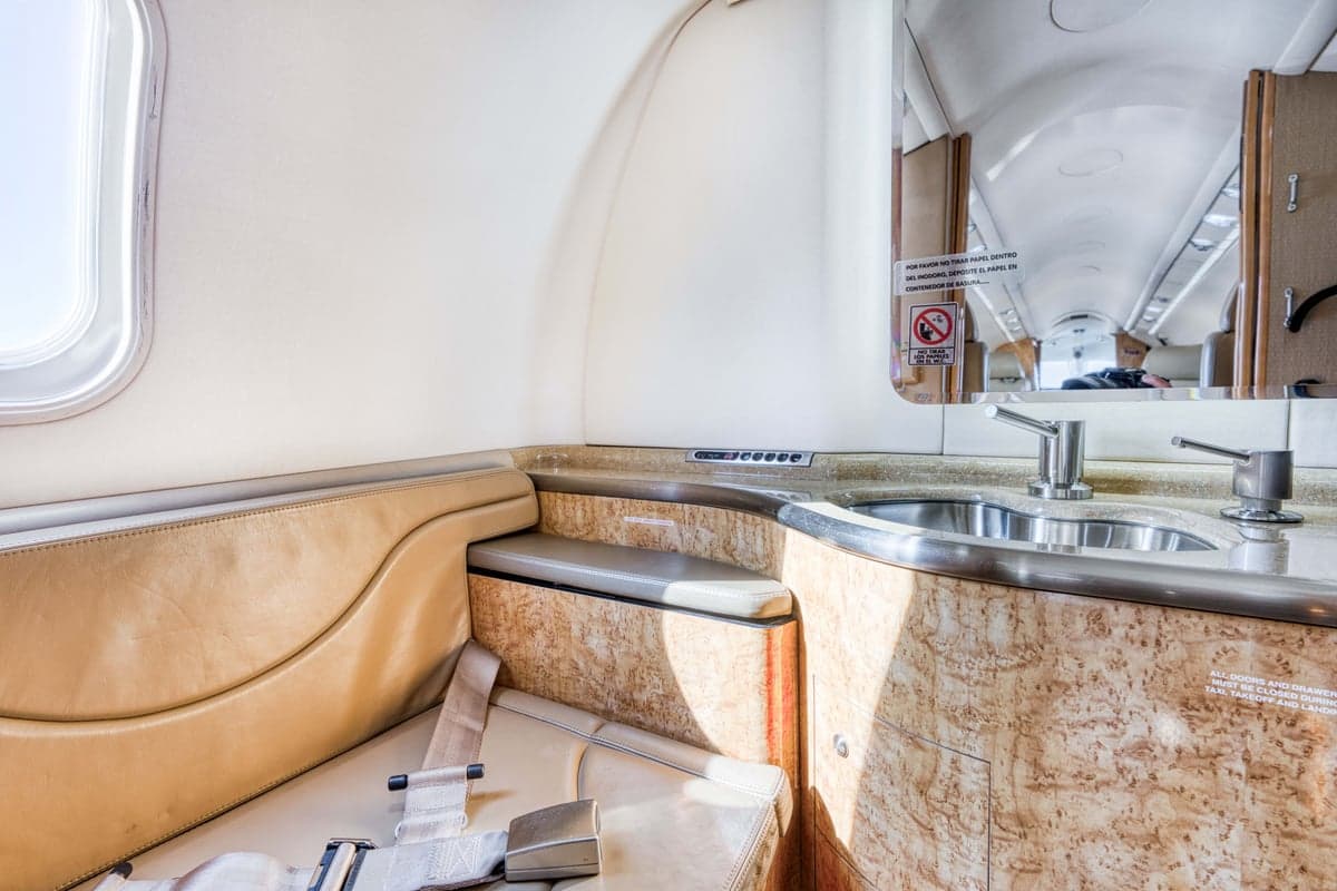 A small lavatory is located in the rear of the aircraft cabin.