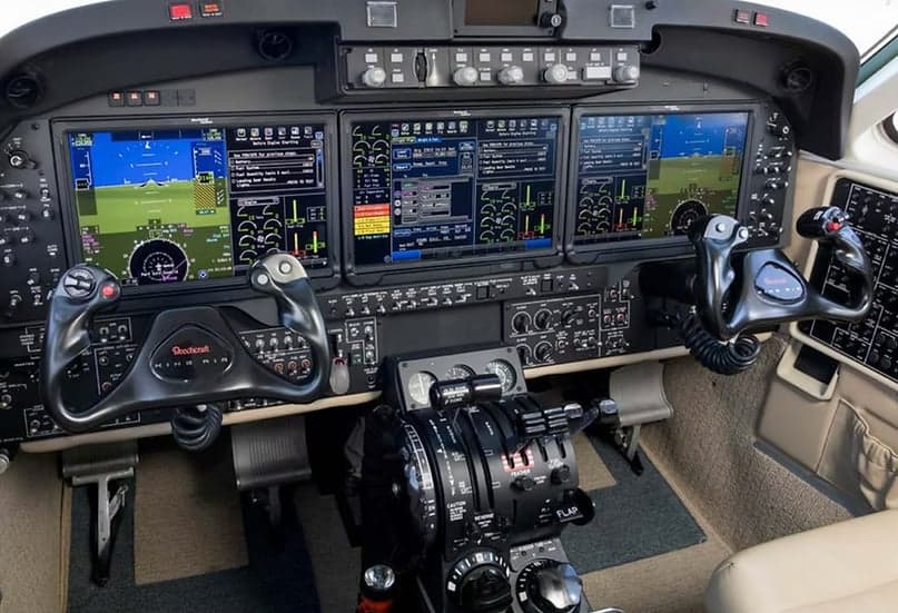 View of the aircraft's cockpit with instrument panel and controls.