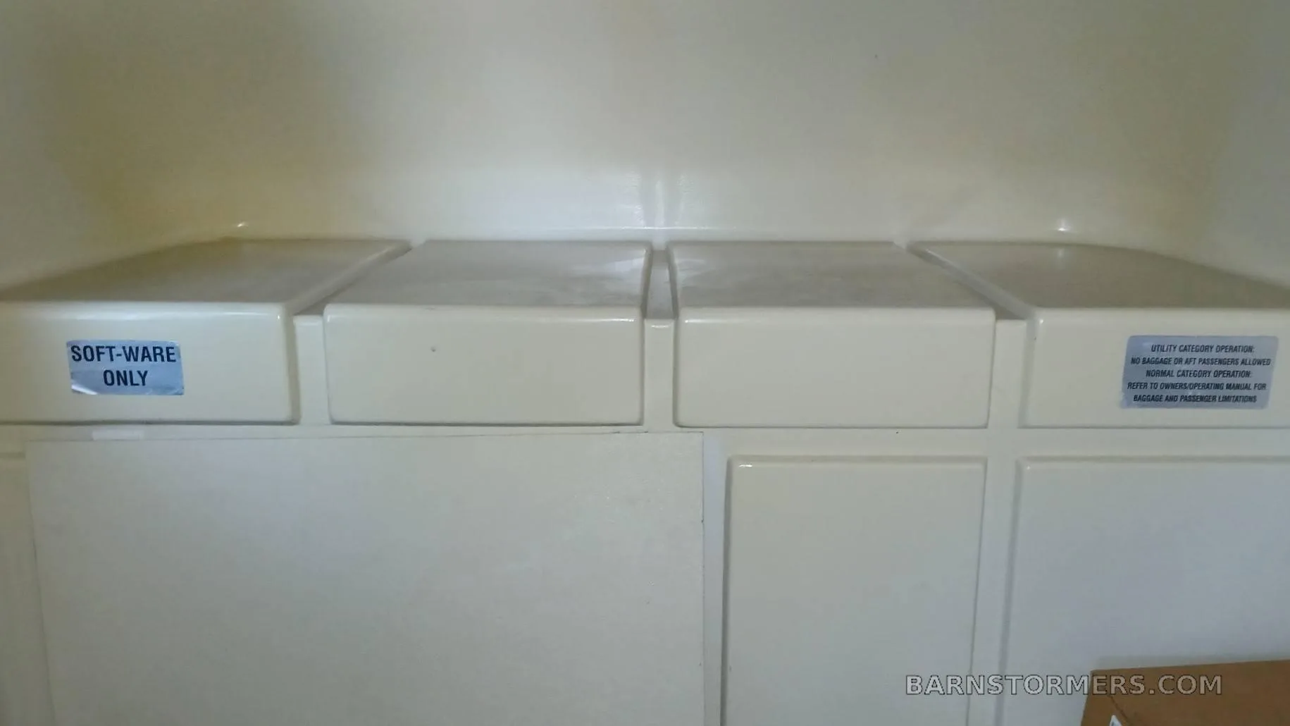 An interior storage area or paneling with "SOFT-WARE ONLY" and utility category operation labels.