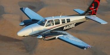 Side view of a Beechcraft Baron on a black background.