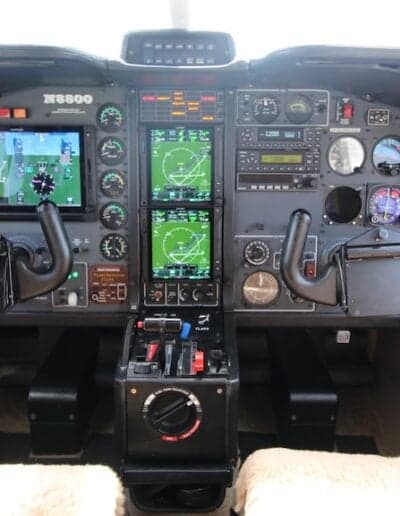 Wide view of the aircraft's cockpit with the instrument panel and control yoke.