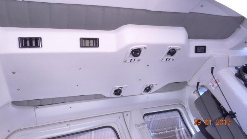 The white ceiling of a helicopter cabin, showing air vents and passenger communication ports.