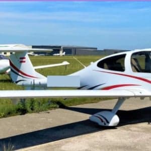 Diamond DA40 aircraft with red and white paint scheme on the tarmac.