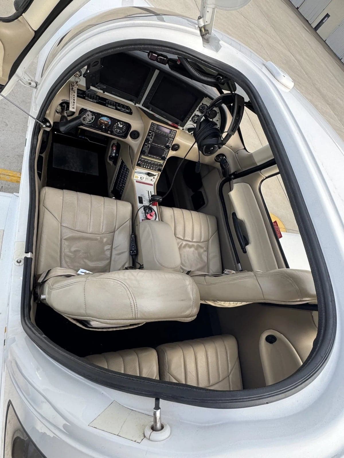 View of the cockpit and cabin seats of a Cirrus SR20 aircraft.