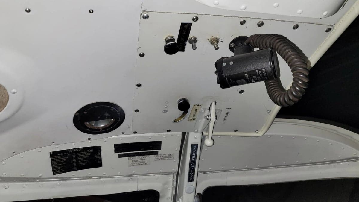 A view of the aircraft's cockpit ceiling with various switches and controls.