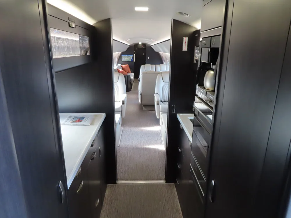 View down the aisle of the aircraft cabin.