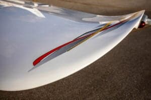 Close-up of the tail of a Cirrus SR22 aircraft with a custom paint scheme.