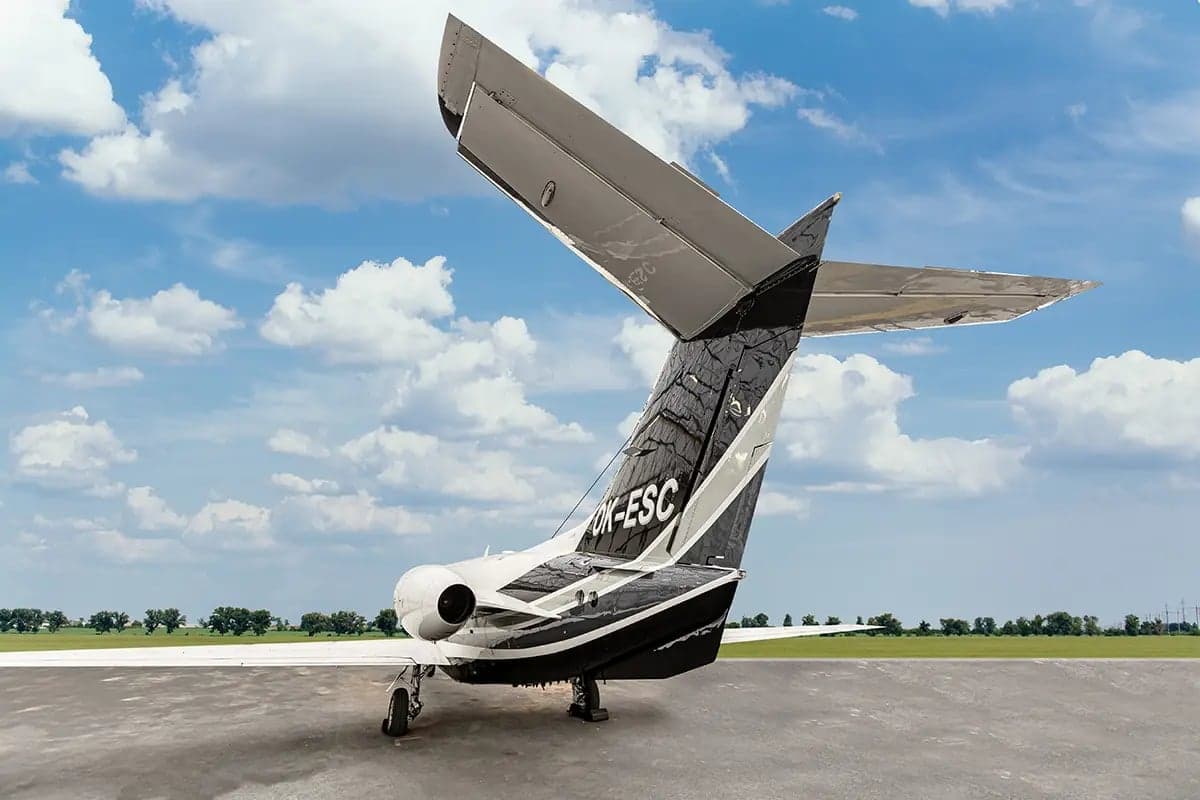 Rear view of the Nextant 400XT aircraft with registration OK-ESC showing the tail and engines.