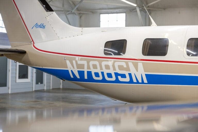 A close-up of the tail and N788SM tail number of the Malibu aircraft.