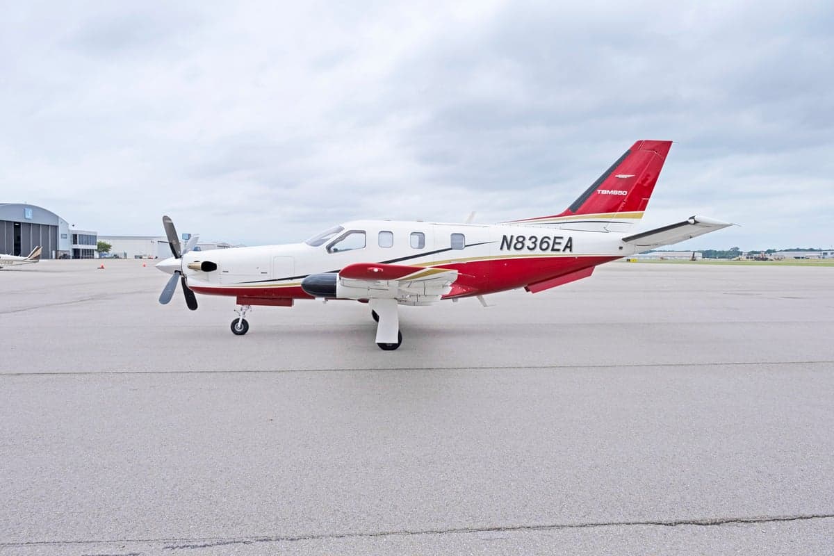 Side view of the TBM 850 aircraft N836EA on the tarmac.
