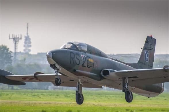 Camouflaged aircraft I-MBCK taking off from a runway.