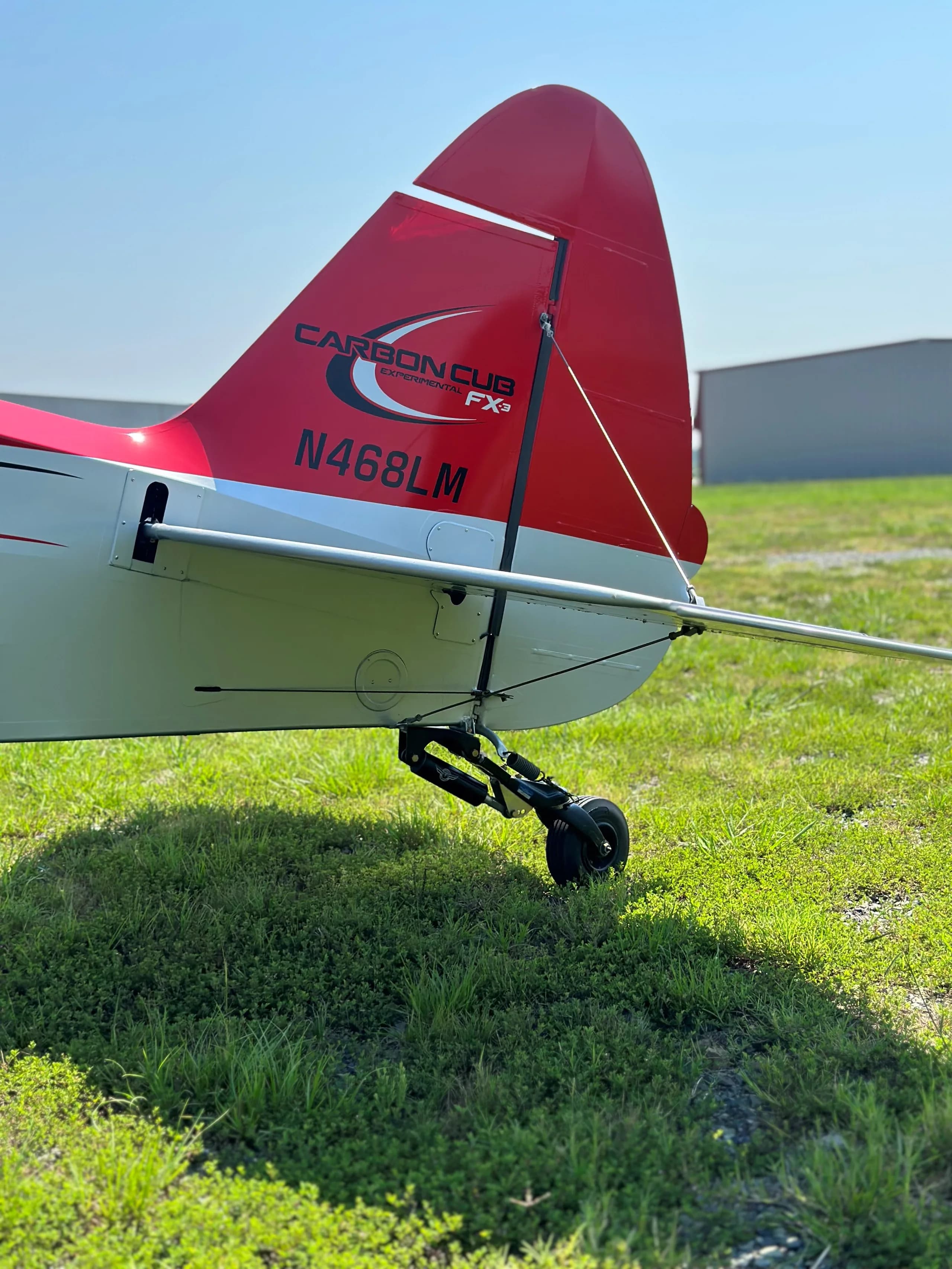 Tail section of a red and silver Carbon Cub FX-3, showing the N number.