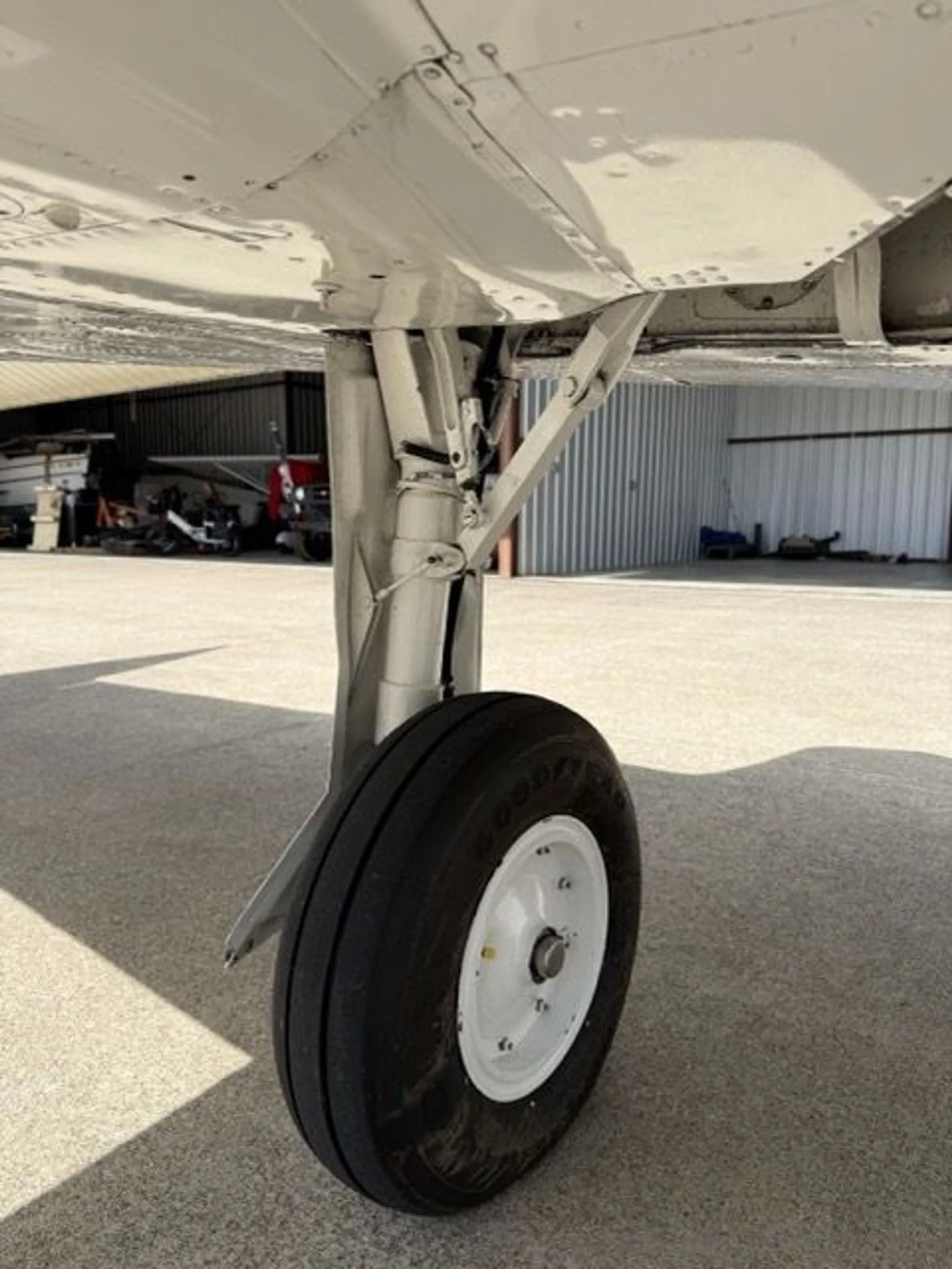 A close-up view of the main landing gear and wheel of the aircraft.