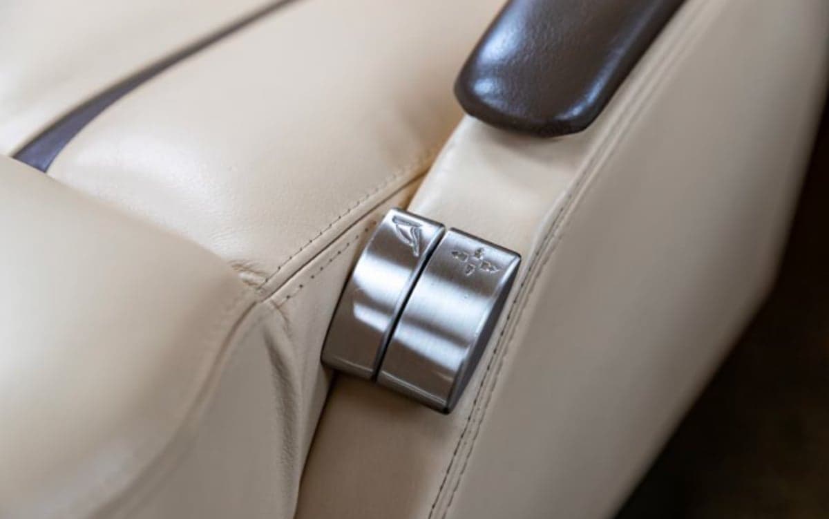Close-up of a seat with metal accents in the aircraft interior.