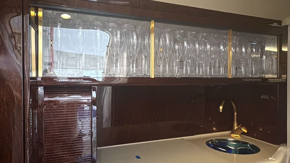 Interior view of the aircraft's bar area with glassware.