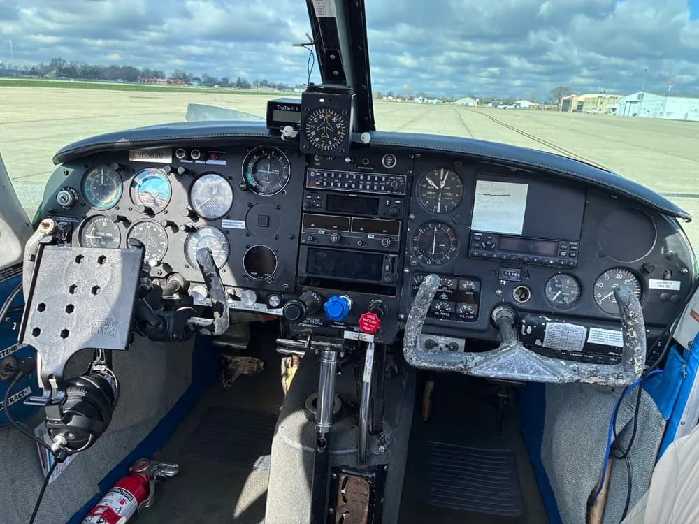 The cockpit of a Piper PA-28-140 Cherokee with a full instrument panel.