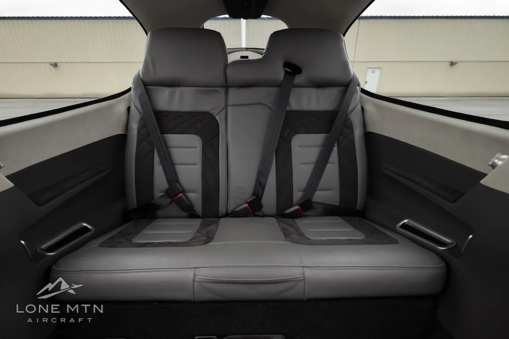 A view of the two gray and dark gray rear cabin seats with seatbelts in the Cirrus Vision Jet.